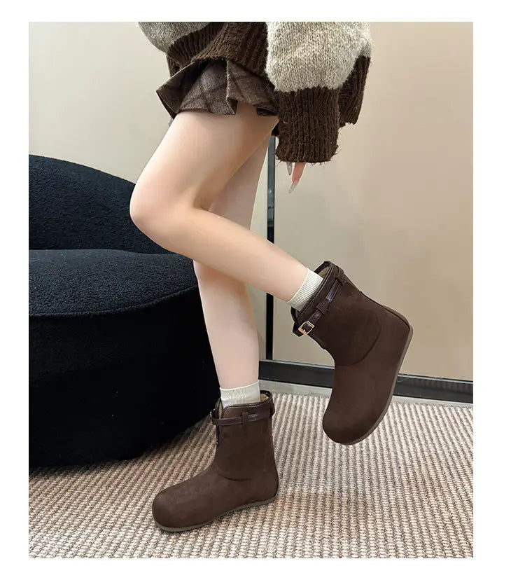 Brown ankle boots with strap detail, side view