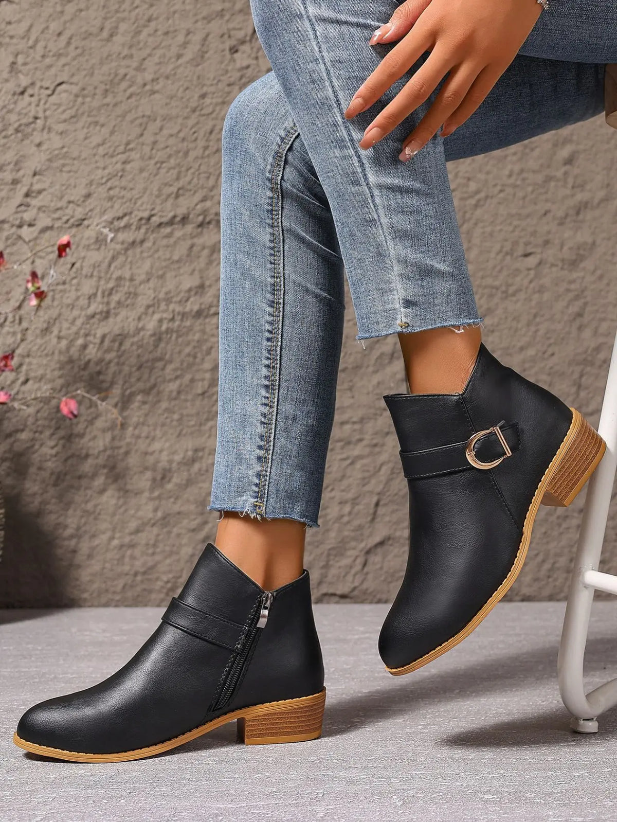 Black ankle boots worn with jeans