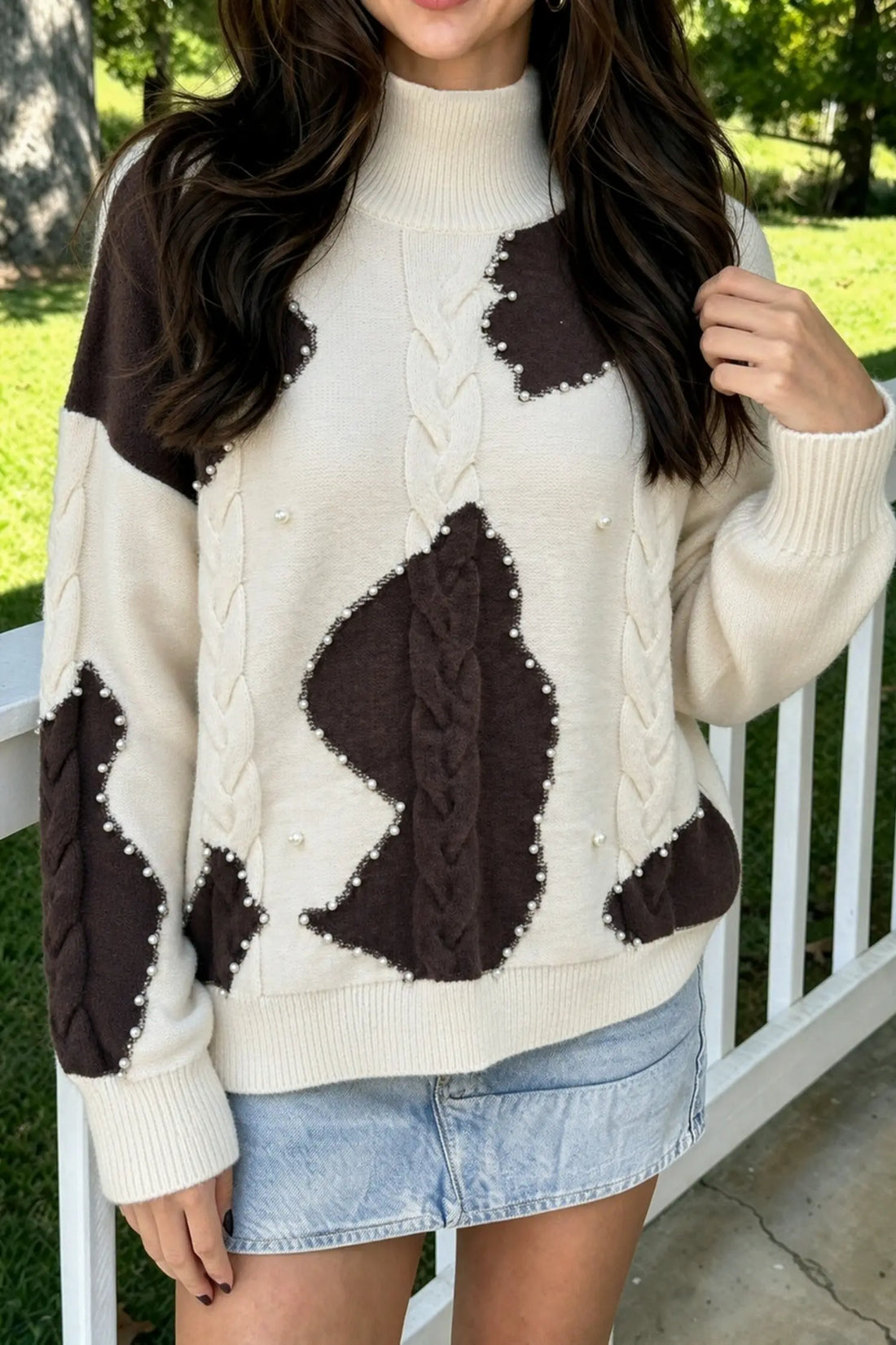 Beige cable knit mock neck sweater with beaded western details