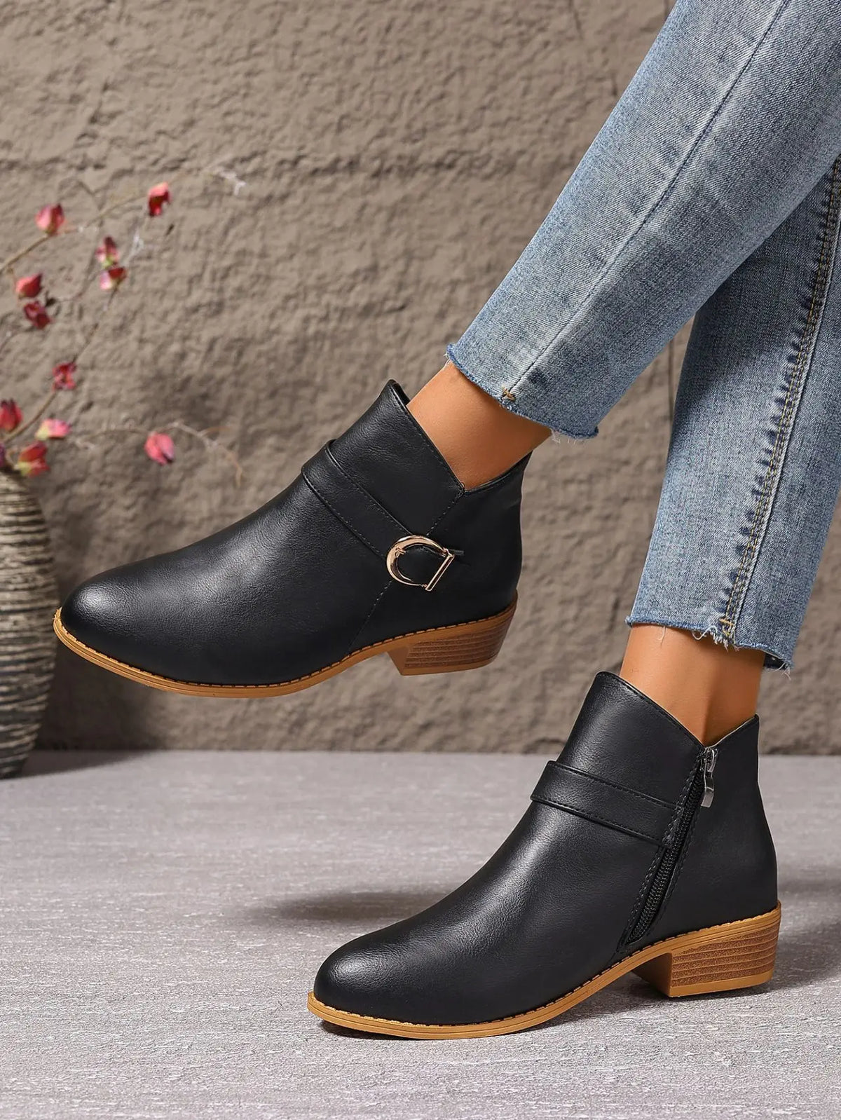 Black ankle boots showing side zip